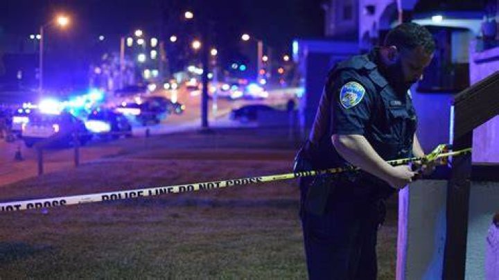 A police officer investigates at the scene of the crash