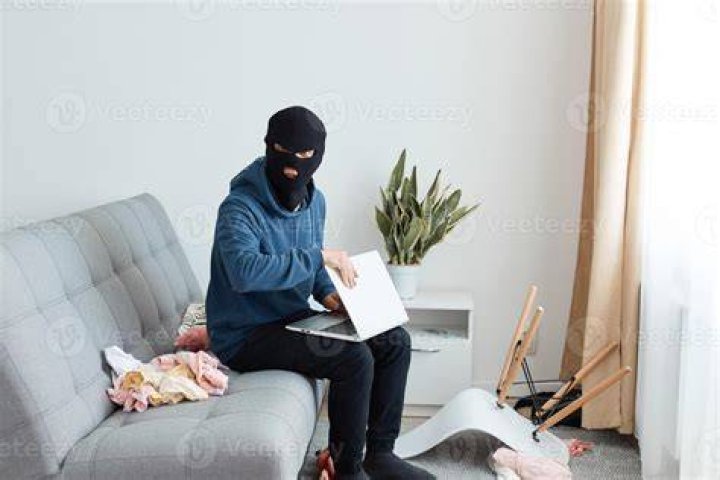 A second burglar wearing blue gloves and a dark jacket is seen piling through the door of the home in Upminster, East London before two others follow