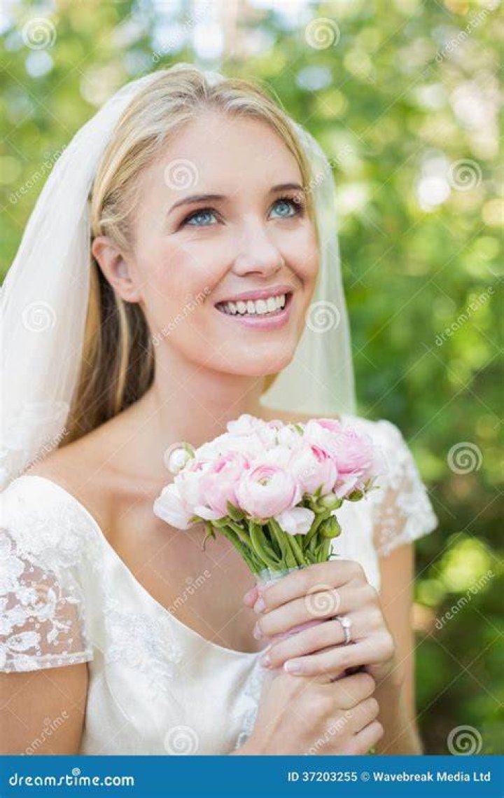 A smiling bride with her loved ones.