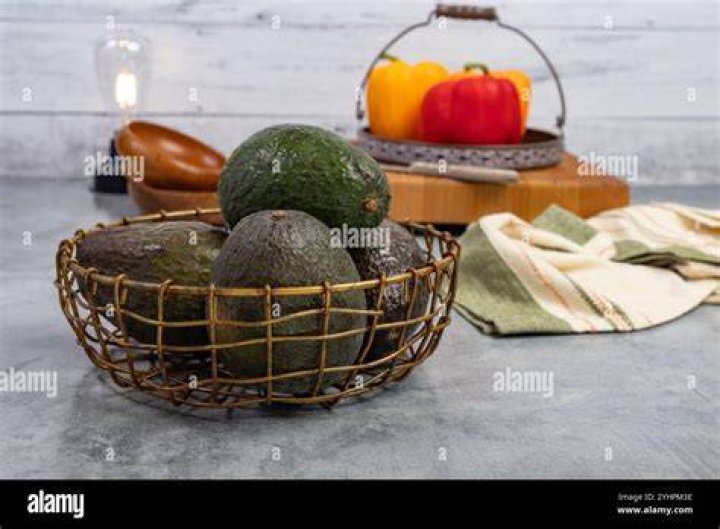 avacados and red peppers on an antique kitchen scales