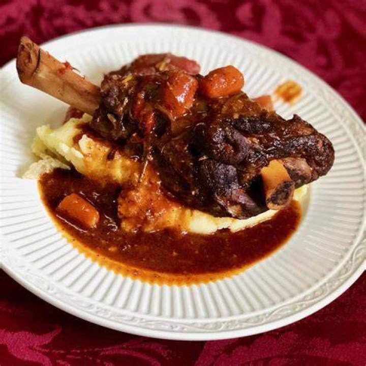 Cabernet-braised lamb shank with Parmesan herb polenta and roasted brussels sprouts. Photo by Jaci Pena:The J Projects