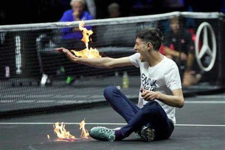 Climate change protester sets arm on fire during Laver Cup match The Independent