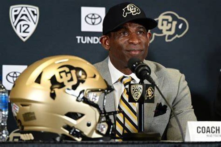 Colorado head coach Deion Sanders talks with his son Shedeur