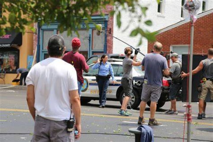 Filming took place in May last year and they chose 22-year-old Lizzie, pictured in the middle, who had never been part of throuple