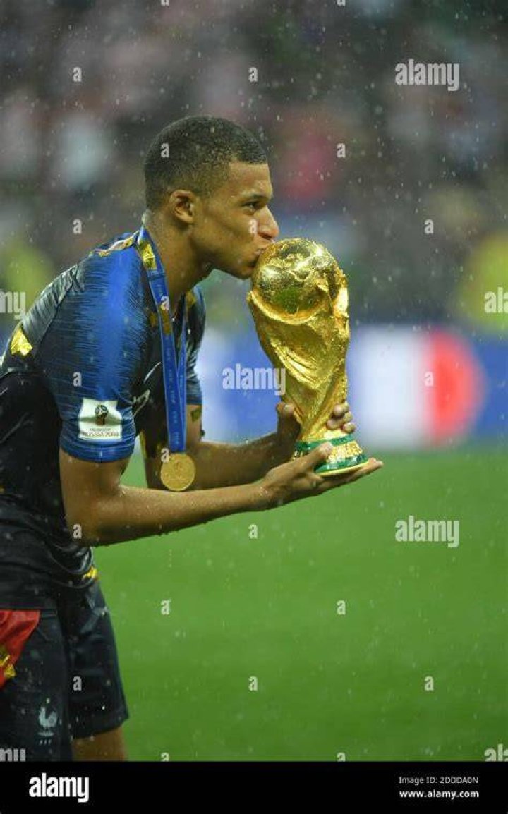 France star Kylian Mbappe kisses the World Cup after their 2018 win