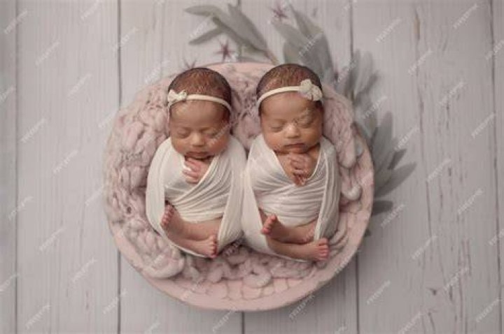 Identical Twin Babies Lying on a Bed