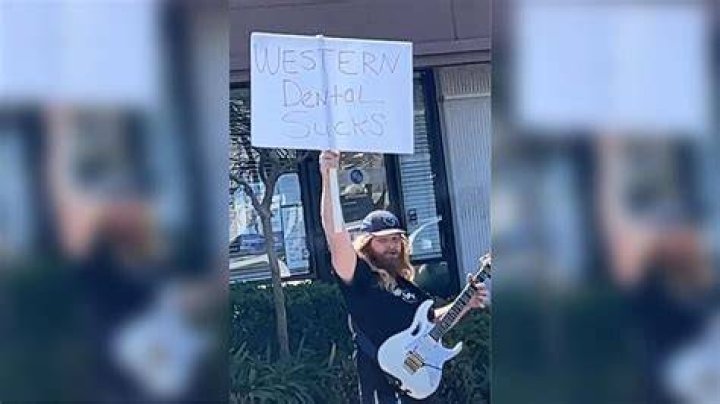 Man Protests Dental Office With Guitar
