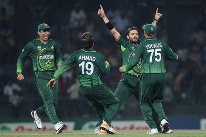 Pakistan players celebrating in a huddle