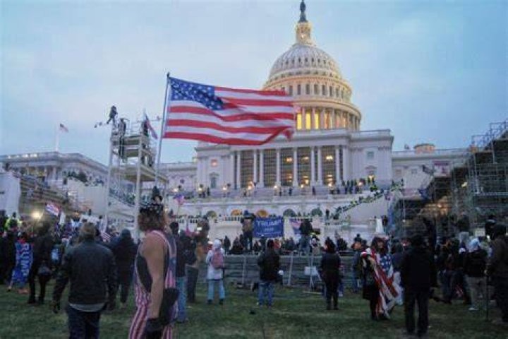 Police defend the Capitol building against pro-Trump rioters by using pepper spray