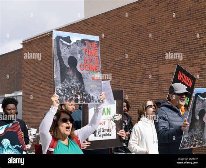 Protesters hold placards as they march during a demonstration to mark the International Day for the Elimination of Violence Against Women