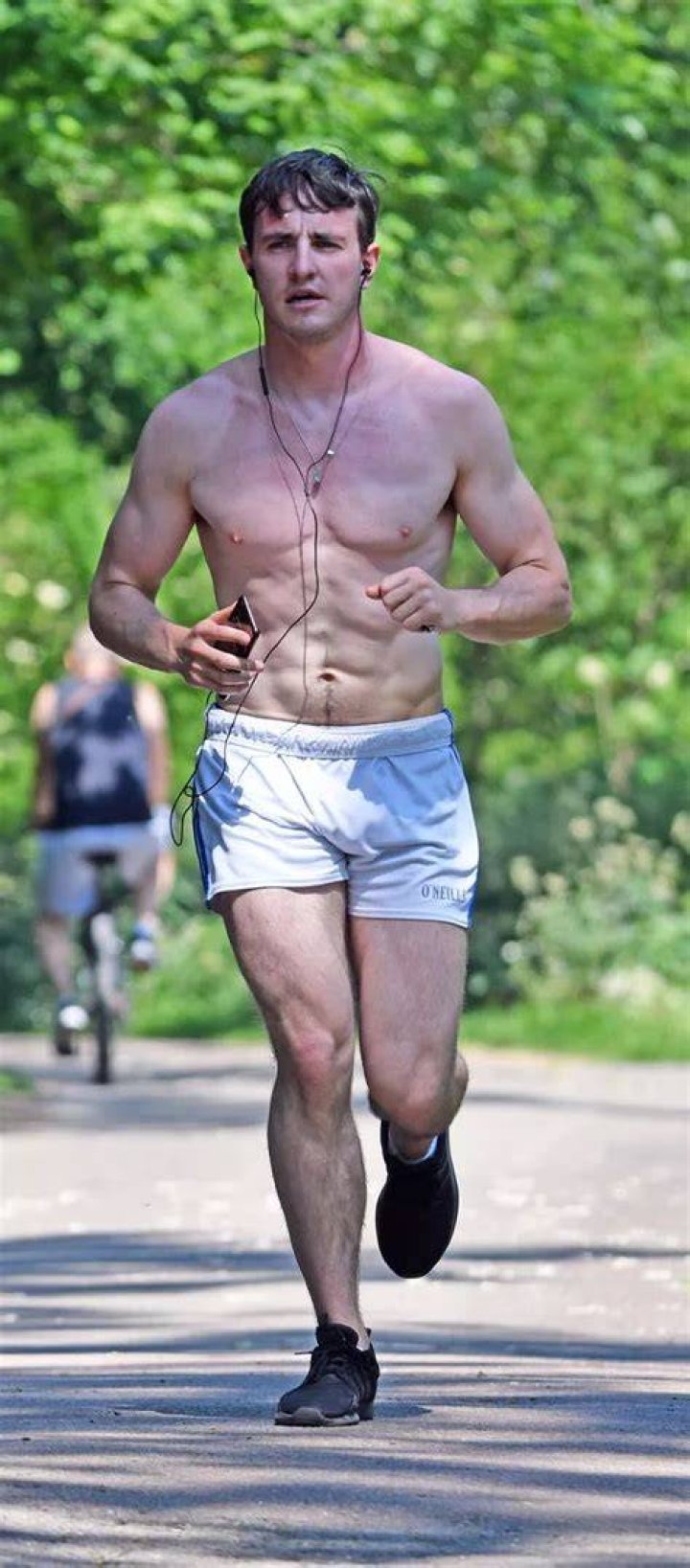Super-toned Paul out jogging near his home in East London