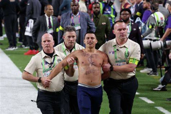 The fan was escorted away from the court and handcuffed in the tunnel