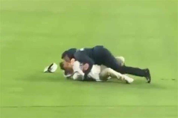 The fan was tackled by security and later arrested