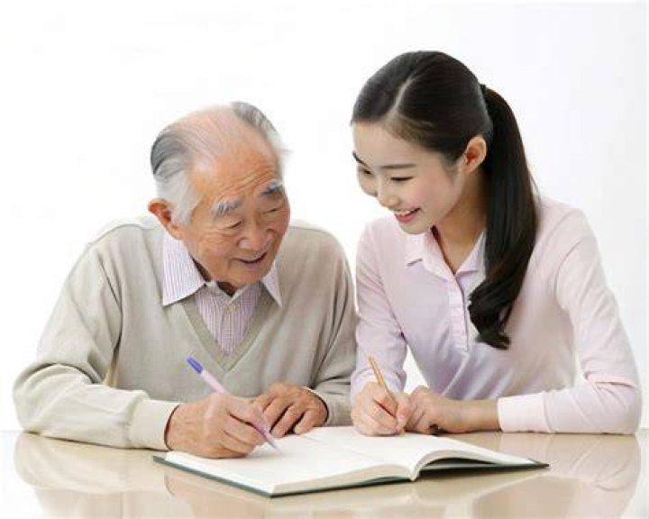 Woman helping man write his last will.