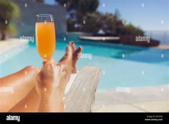 Woman sunbathing with fruit juice
